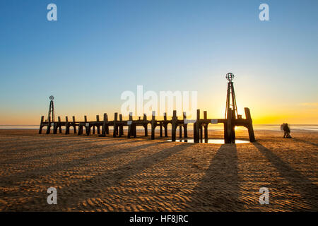 Sunset over Lytham old wooden jetty;  Lancashire, UK. 29th December, 2016. UK WEATHER: A stunning sunset over the old wooden pier at Lytham St. Annes.  The eroded wooden jetty is all that remains years after it became redundant.  Clear skies mean another cold & frosty night over the north west of England. Stock Photo