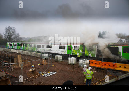 Main Line near Leamington Spa, UK. 30th Dec, 2016. Prototype D Train 230 001 caught fire while on test at Kenilworth along the main railway line between Coventry and Leamington Spa on 30 December 2016. The train, heralded as an innovative concept, is a converted London Underground Tube train that runs on  diesel engines that provide electrical current to the trains traction motors. The D Train is believed to have been completing its final main line testing. Credit: Fraser Pithie/Alamy Live News Stock Photo