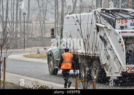 Hanover, Maryland, USA. 30th December, 2016. The Anne Arundel County garbage team is driving through neighborhoods while collecting trash on a snowy winter day in Anne Arundel County Maryland. Credit: Jeramey Lende/Alamy Live News Stock Photo