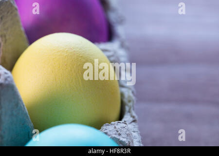 Colorful Easter eggs in egg carton. Stock Photo