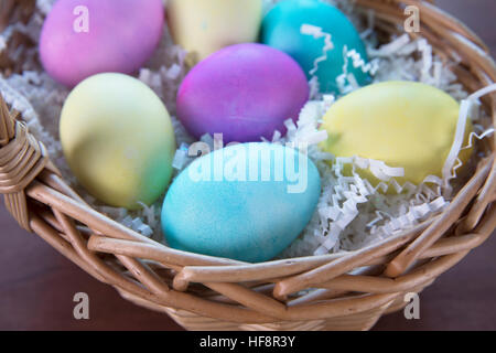 Colorful Easter eggs in Easter basket. Stock Photo