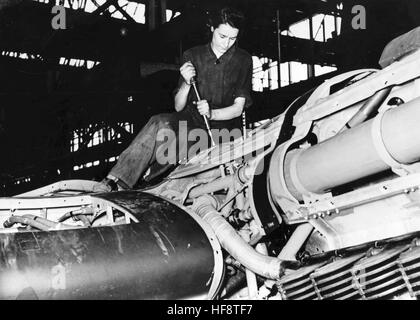 The Nazi propaganda image shows a woman assembling a Heinkel He 111 combat plane in the assembly line hall at Ernst Heinkel Plane Manufacturers. Published in May 1942. A Nazi reporter has written on the reverse on 01.05.1942, 'The Man and his Works. The assembly of the engine cover of the Heinkel combat plane is women's work.  [Further pictures from this photo series are under the title, 'Der Mann und sein Werk' (The Man and his Works - referring to Ernst Heinkel, airplane manufacturer).] Fotoarchiv für Zeitgeschichte - NO WIRELESS SERVICE -  | usage worldwide Stock Photo