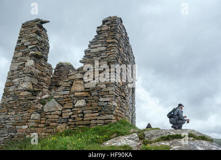 Hiker by the ruins of Castle Varrich Tongue, Sutherland ,Scotland Stock Photo