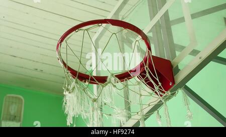 basketball hoop and a billboard in the school gym sport Stock Photo