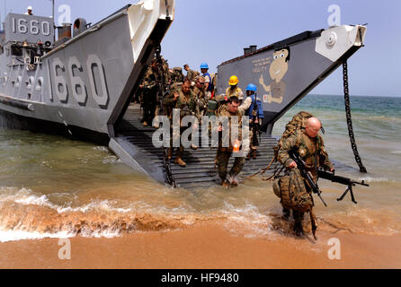 U.S. Marines assigned to a Security Cooperation Marine Air-Ground Task Force disembark from Landing Craft Utility 1660 assigned to Assault Craft Unit 2 in Guereo, Senegal, April 6, 2010, during an offload of U.S, Spanish, Portuguese and British marines and Seabees assigned to Naval Mobile Construction Battalion 7. The service members will be working with the Senegalese army as part of Africa Partnership Station West, an international initiative developed by U.S. Naval Forces Europe/Africa to work on improving maritime safety and security on the African continent. (DoD photo by Mass Communicati Stock Photo