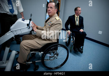 Chairman of the Joint Chiefs of Staff Navy Adm. Mike Mullen tests a robotic wheelchair endurance and skill prototype at Excellence for Wheelchair and Related Technology in Pittsburgh April 19, 2010. Mullen and his wife, Deborah, have embarked on a Conversation with the Country tour, the first leg in a yearlong series of stops at universities to discuss issues that are important to the military and how educational institutions can help veterans and their families. (DoD photo by Mass Communication Specialist 1st Class Chad J. McNeeley, U.S. Navy/Released) 100419-N-0696M-449 (4538750668) Stock Photo