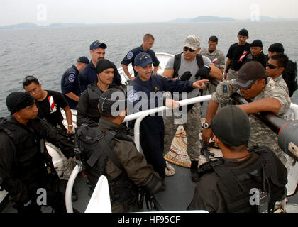 110614-N-NJ145-272 KEMAMAN, Malaysia (June 14, 2011) Malaysian Maritime Enforcement Agency Star Team members and U.S. Coast Guard Maritime Safety and Security Team personnel debrief a training scenario aboard a Malaysian offshore patrol vessel during a tactical boarding training exercise for Cooperation Afloat Readiness and Training (CARAT) Malaysia 2011. CARAT is a series of bilateral exercises held annually in Southeast Asia to strengthen relationships and enhance force readiness. (U.S. Navy photo by Mass Communication Specialist 1st Class Robert Clowney/Released) CARAT Malaysia 2011 (110614 Stock Photo