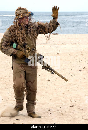 100717-N-0683T-292 VIRGINIA BEACH, Va. (July 17, 2010) A U.S. Navy SEAL sniper waves to the crowd during a capabilities demonstration at Joint Expeditionary Base Little Creek, Va. The Naval Special Warfare community event was part of the 41st UDT/SEAL East Coast Reunion celebration. (U.S. Navy photo by Chief Mass Communication Specialist Stan Travioli/Released) 100717-N-0683T-292 (4815262703) Stock Photo