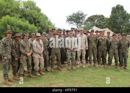 SINGO, Uganda (March 1, 2012) – U.S. Navy Rear Admiral Michael Franken, Combined Joint Task Force – Horn of Africa commander, poses with Marines assigned to Security Cooperation Team-2, Special Purpose Marine Air Ground Task Force-12, Naval Air Station, Italy, while visiting here March 1. The Marines exchanged best practices in counter-terrorism combat engineering techniques with Uganda People’s Defence Force soldiers for use by infantry battalions deployed as part of the African Union Mission in Somalia. (Courtesy photo by Hakeem Buuza) CJTF-HOA commander visits US personnel in Uganda 120301- Stock Photo