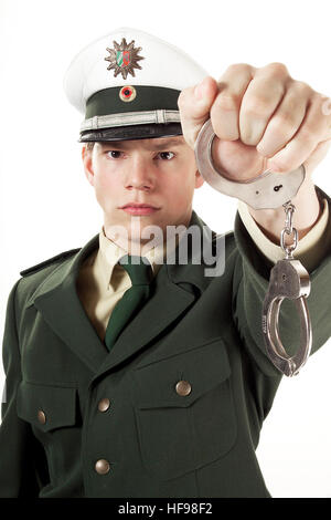 Police officer holding handcuffs Stock Photo - Alamy