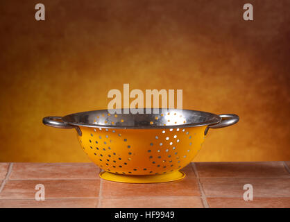 colander yellow on the table Stock Photo