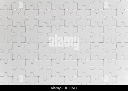 Blank white jigsaw puzzle pieces completed as copy space Stock Photo