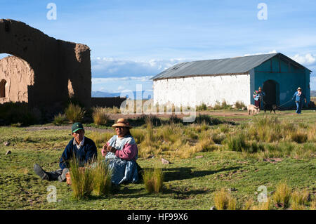 Local people at Peruvian altiplano landscape seen from inside the Andean Explorer train Orient Express which runs between Cuzco and Puno. Altiplano is Stock Photo