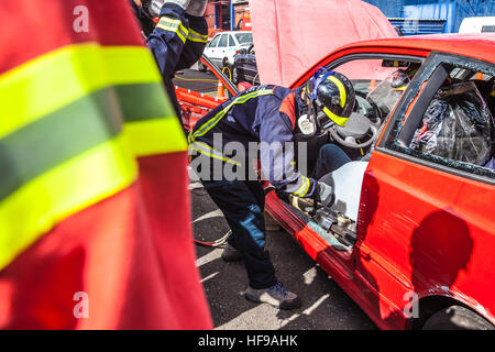 firemen during a car accident simulation Stock Photo