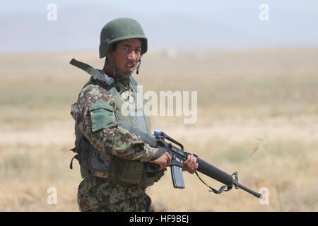 An Afghan National Army soldier conducts a security patrol near Camp Leatherneck May 17, 2014 in the Helmand province, Afghanistan. Stock Photo