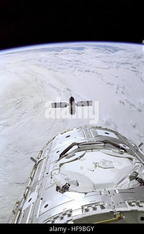 NASA STS-88 crew members aboard the space shuttle Endeavour ready the Remote Manipulator System to capture the Russian-built Zarya Functional Cargo Block module near the International Space Station Unity Node 1 December 6, 1998 in Earth orbit. The FGB was the first module of the ISS to be launched. Stock Photo