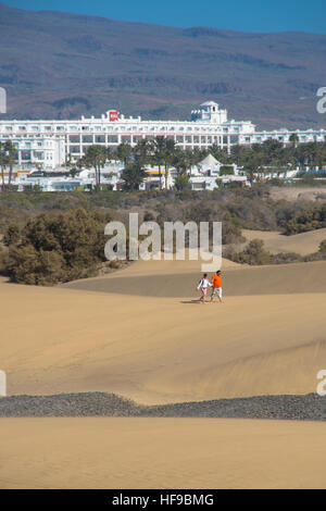 couple walking in sand dunes at maspalomas gran canaria spain Stock Photo