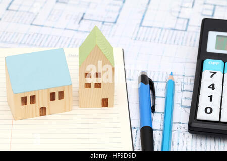 Miniature model of house and blueprints, construction plan Stock Photo