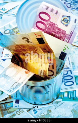 Euro bills stuffed into a tin Stock Photo