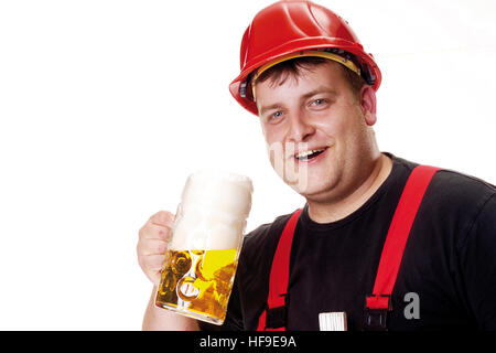 Construction worker wearing red hardhat holding a mug of beer Stock Photo