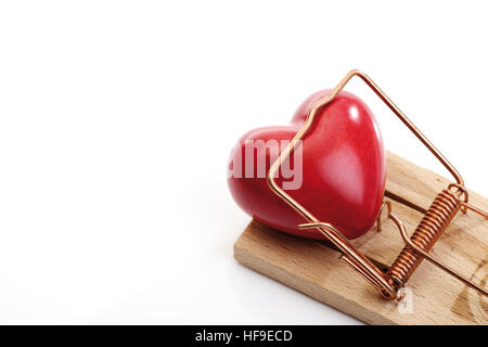 Heart caught in a mousetrap Stock Photo