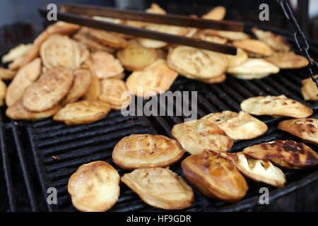 Traditional Polish smoked cheese made of salted sheep milk known as oscypek on barbecue Stock Photo