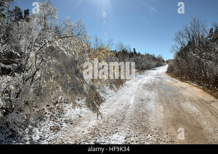 Russia, the Caucasus, Republic of Adygeya. Road in the snow-covered foothills. Rain and snow. Stock Photo