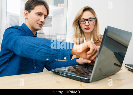 Two managers working using laptop in office Stock Photo