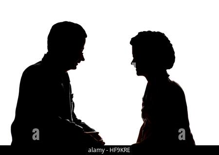 A silhouette of a senior elderly couple in conversation.model figurines. Stock Photo