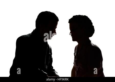 A silhouette of a senior elderly couple in conversation. model figurines. Stock Photo