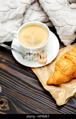 cup of coffe and croissant on wooden background Stock Photo