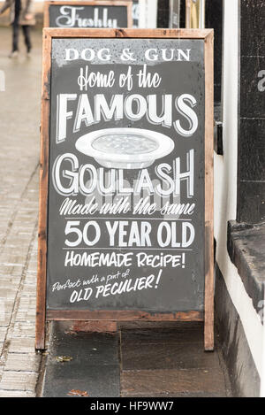 A sign outside the Dog and Gun pub in Keswick advertising theor famous Hungarian Goulash food Stock Photo