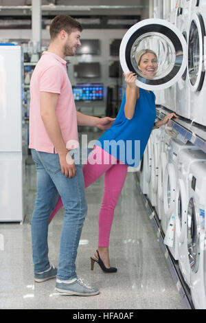 Beautiful Young Couple Shopping For Washing Machine In Produce Department Of A Grocery Store - Supermarket - Shallow Deep Of Field Stock Photo