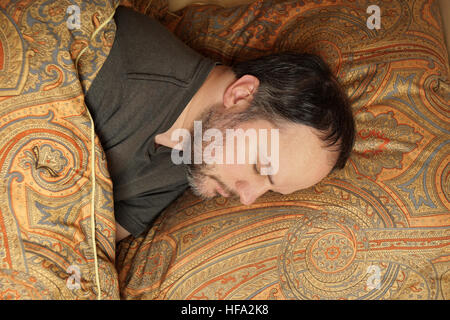 man sleeping in bed Stock Photo
