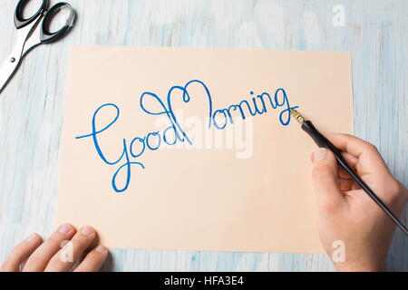 Man writing a good morning note top view Stock Photo