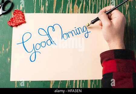 Man writing a good morning note top view Stock Photo