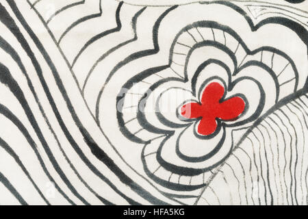 hand painted silk batik - red flower between black curved lines on white cloth Stock Photo