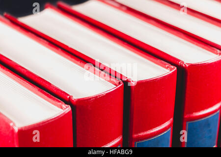 Old red encyclopedias bound leather on black background Stock Photo