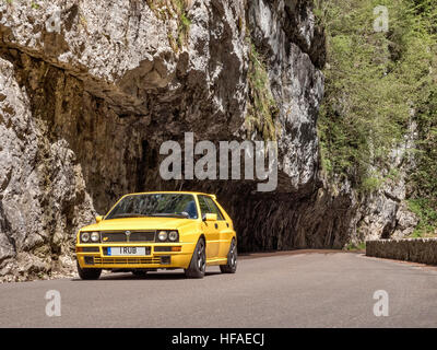 1995 Lancia Delta HF Integrale driving on roads in the French alps Stock Photo