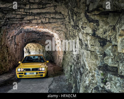 1995 Lancia Delta HF Integrale driving on roads in the French alps Stock Photo