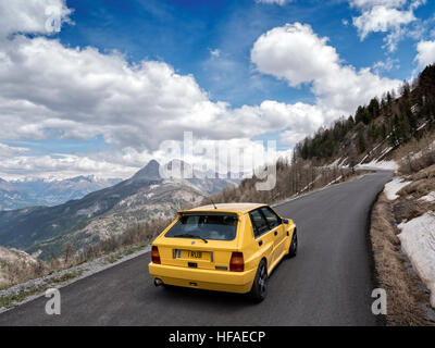 1995 Lancia Delta HF Integrale driving on roads in the French alps Stock Photo