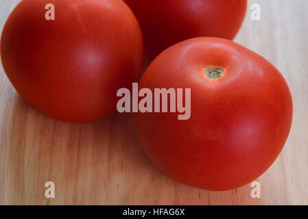 Three round, ripe tomatoes. Stock Photo