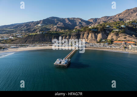Aerial of the historic Malibu Pier, beaches and the Santa Monica Mountains on the Southern California Pacific Coast.