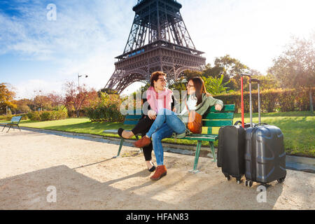 Friends talking to each other near Eiffel Tower Stock Photo