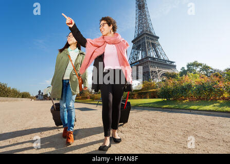 Two happy female tourists walking around Paris Stock Photo