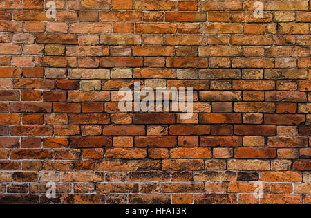 An ancient reddish brick wall closeup Stock Photo