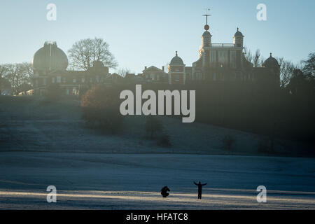 A boy poses for a photo near the Royal Observatory in Greenwich Park, south east London, after a night of freezing fog and sub-zero temperatures across the southern parts of UK. Stock Photo