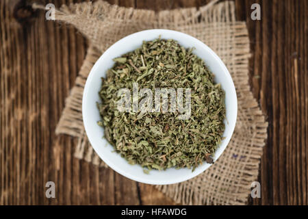 Old wooden table with dried Stevia leaves (close-up shot; selective focus) Stock Photo