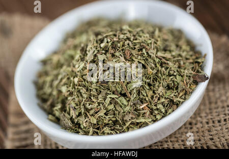 Old wooden table with dried Stevia leaves (close-up shot; selective focus) Stock Photo