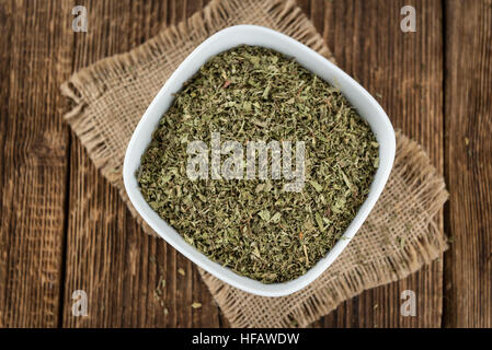 Old wooden table with dried Stevia leaves (close-up shot; selective focus) Stock Photo